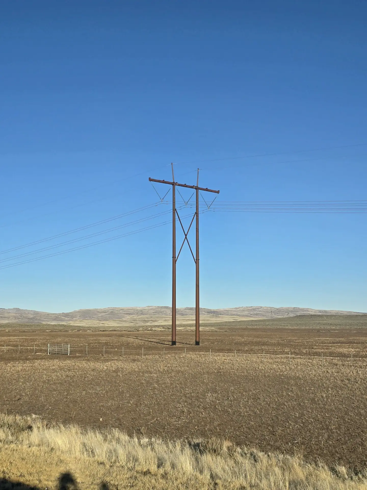 H-frame steel transmission structure on open rangeland